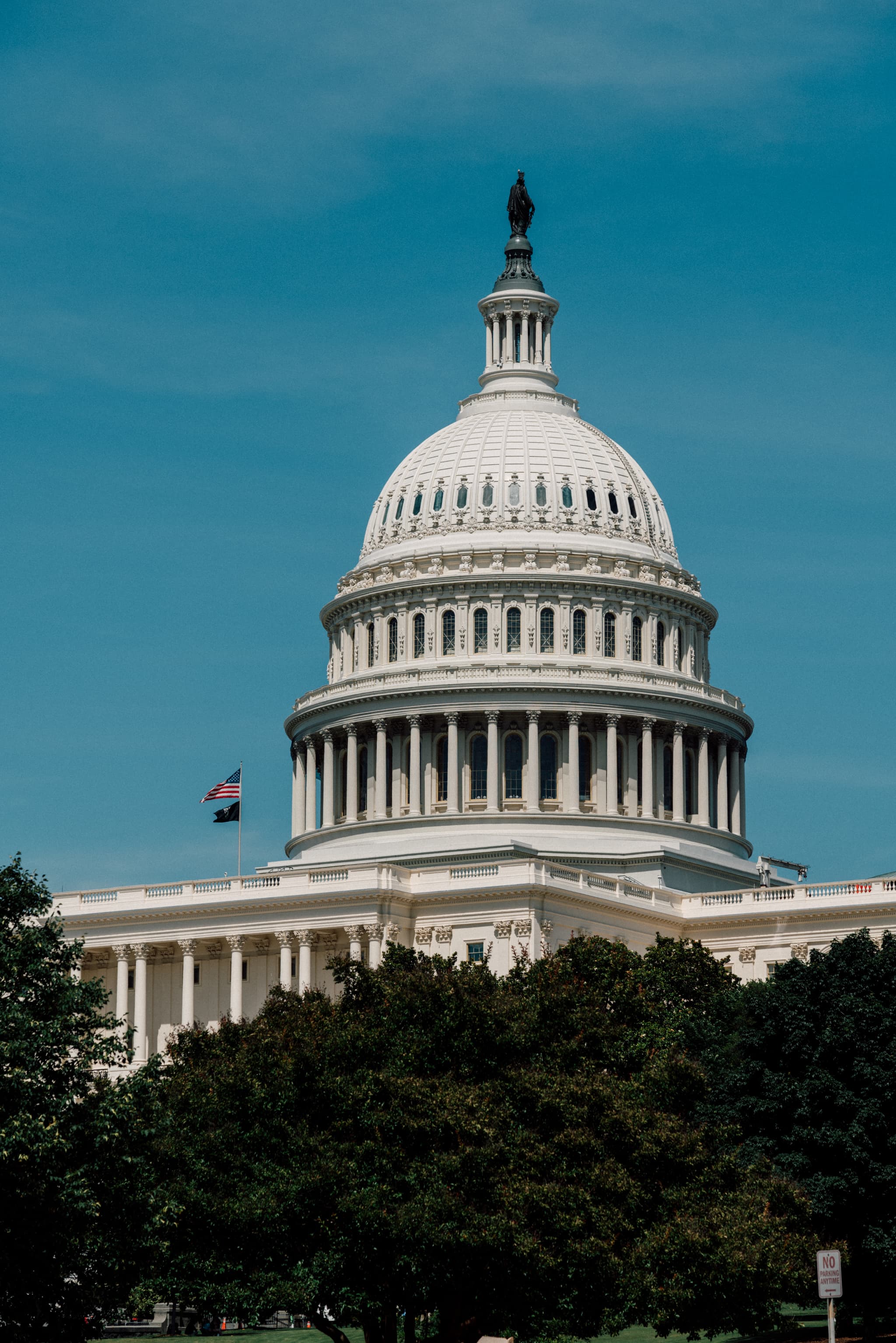 A view of the United States Capitol building with a clear blue sky in the background