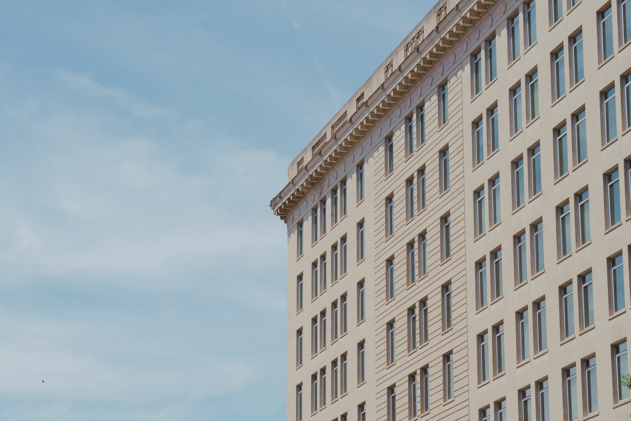 A corner view of a multi-story building against a clear sky