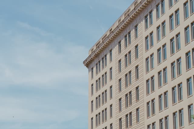 A corner view of a multi-story building against a clear sky