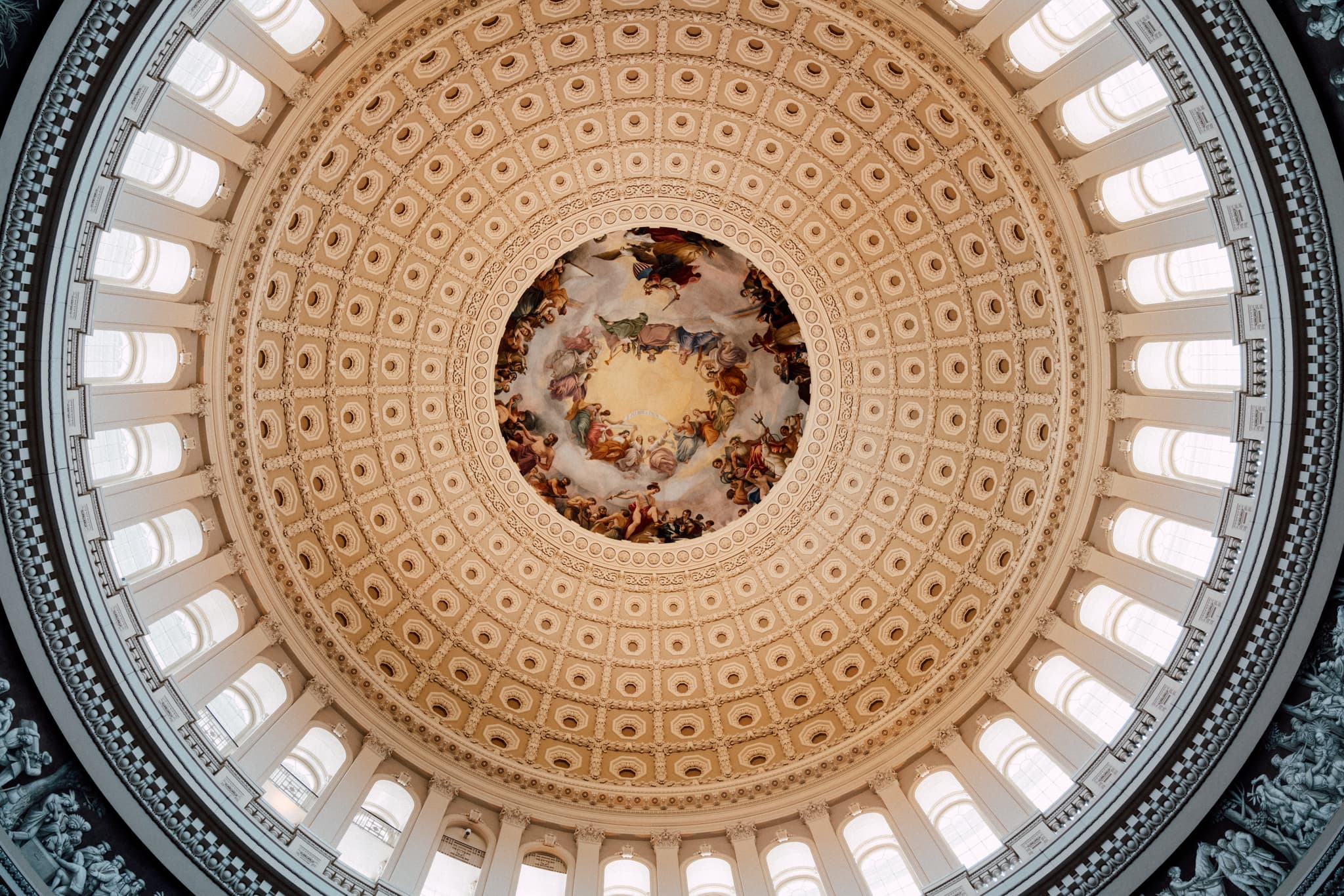 An ornate dome ceiling with intricate patterns and a central painting